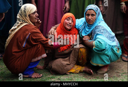 India. 03rd May, 2018. Kashmiri women soothing the sister of a slain civilian, Umar Abdullah Kumar in Pinjoora area of South Kashmirs Shopian district on Thursdayin Indian Controlled Kashmir, May 03, 2018. A civilian was killed while dozens sustained injuries during the intense clashes that erupted following the encounter between militants and forces in the district. However, the militants who were trapped have managed to escape from the site, police said. Credit: Umer Asif/Pacific Press/Alamy Live News Stock Photo