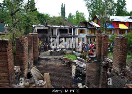 India. 03rd May, 2018. Residents looking at the debris of a residential house that was damaged during the encounter in Turkwangam village of South Kashmir's Shopian district on Thursday in Indian controlled Kashmir, May 03, 2018. A civilian was killed while dozens sustained injuries during the intense clashes that erupted following the encounter between militants and forces in the district. However, the militants who were trapped have managed to escape from the site, police said. Credit: Umer Asif/Pacific Press/Alamy Live News Stock Photo