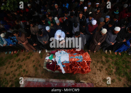 Shopian, India. 03rd May, 2018. (EDITORS NOTE: Image depicts death) School shirt is placed on the body of a teenager, Umar Kumar as people offer funeral prayer in Pinjoora some 50 kilometers from Srinagar the summer capital of Indian controlled Kashmir on May 03, 2018. Umar was shot dead by government forces after the clashes erupt following a gun battle between rebels and Indian forces in Turkewangam area of south Kashmir's Shopian. Later the rebels managed to escape from the site of gun-battle, local residents said. Credit: Faisal Khan/Pacific Press/Alamy Live News Stock Photo