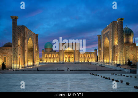 Samarkand at dusk. Historic Registan square with three madrasahs: Ulugh Beg, Tilya-Kori and Sher-Dor  Registan square at dusk - the ancient center of  Stock Photo