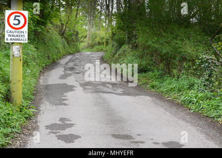 Speed limit of 5 mph on a narrow country road at the seaside town of Seaton, Devon, England. Stock Photo