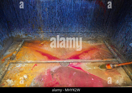 Cleaning thinner brush in a print factory colorful sink ink drops Stock Photo