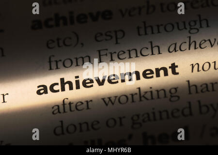 achievement word in a dictionary. achievement concept. Stock Photo