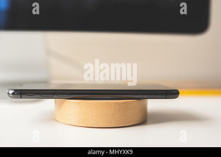 Mobile placed on wireless charger. Future technology concept Stock Photo
