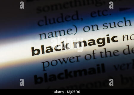 magic word in a dictionary. black concept Photo - Alamy
