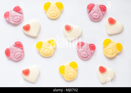 percy pig sweets congratulations percy and penny with strawberry hearts to celebrate the big day - set on white background Stock Photo