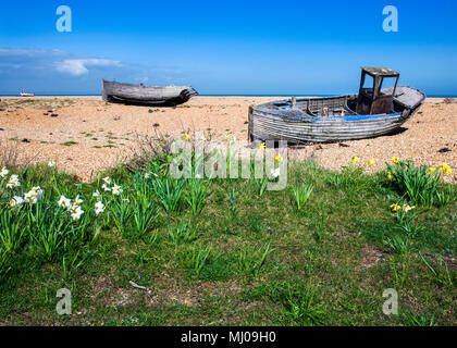 A derelict clinker-built wooden fishing boat with wheelhouse,abandoned on the shingle beach at Dungeness, Sussex, England Stock Photo