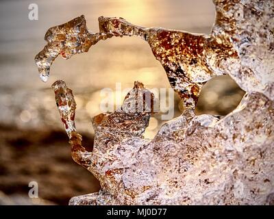 Detail of melting ice block floating in the river. Frozen river surface covered with soft ice Stock Photo