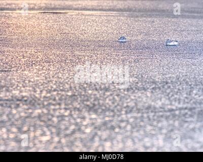 Blured ice floe. Sunset colors in natural ice. Nice natural bokeh defocused sparkling lights in ice. Stock Photo