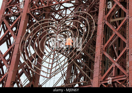 A maintenance workman repairing the lights on the fascia of Blackpool tower on the seafront promenade at Balckpool in Lancashire, UK. Stock Photo