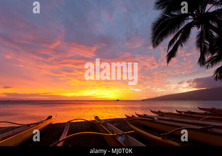 Beautiful sunset with outrigger canoes at Kihei, Maui, Hawaii. Stock Photo