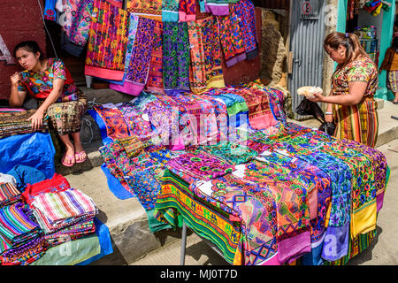 Santiago Sacatepequez, Guatemala - November 1, 2017: Women dressed in traditional clothing sell textiles during giant kite festival on All Saints' Day
