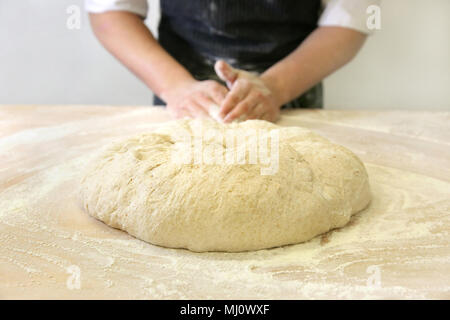 Making dough by male hands at bakery Stock Photo