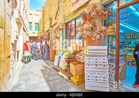 DOHA, QATAR - FEBRUARY 13, 2018: The narrow backstreet of Souq Waqif with row of small shops, on February 13 in Doha Stock Photo