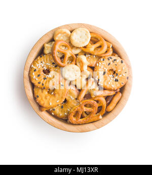 Mixed salty snack crackers and pretzels in bowls isolated on white background. Stock Photo