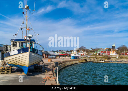 Sandvik, Oland, Sweden - April 7, 2018: Travel documentary of everyday life and environment. The small village harbor with fishing boats on the pier.  Stock Photo