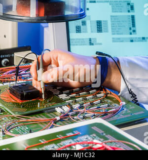 Hands working in a electronic test and analysis labratory Stock Photo