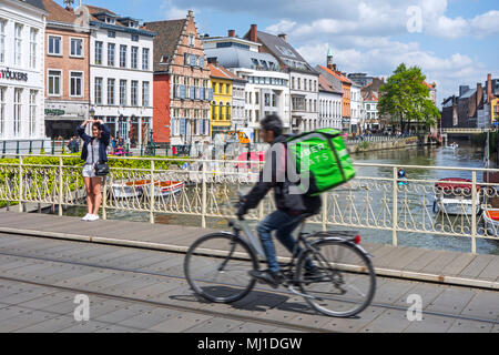 UberEATS / Uber Eats online meal ordering and delivery platform, bicycle courier delivering meals in the city center of Ghent, Belgium Stock Photo