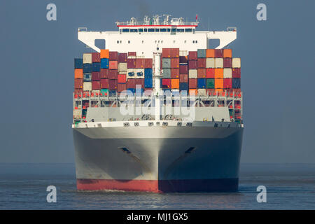 Front view of a large shipping container ship in the ocean. Stock Photo