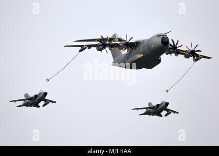 BERLIN - APR 27, 2018: German Air Force Airbus A400M plane aerial refuelling two Tornado fighter bombers during the Berlin ILA Air Show. Stock Photo