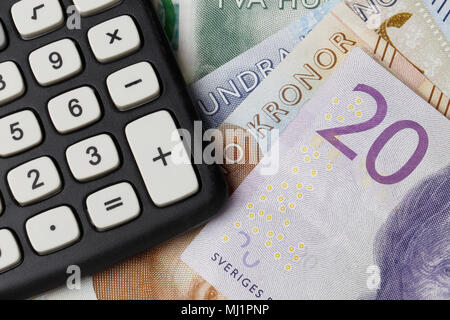 Close up of a calculator on Swedish money. Stock Photo