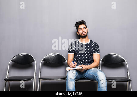 Young man waiting for job interview in reception hall Stock Photo