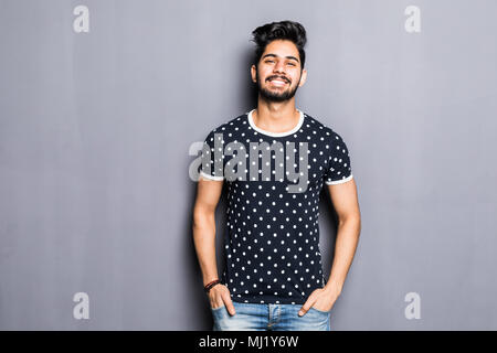 Indian young man in t-shirt over gray background Stock Photo