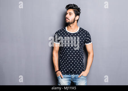 Indian young man in t-shirt over gray background Stock Photo