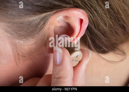 Close-up Photo Of Woman Wearing Hearing Aid Stock Photo