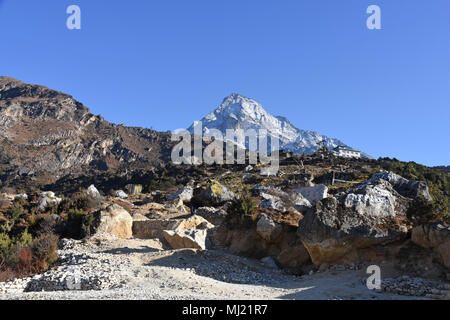 Prayer stones above Namche Bazaar and snowcapped Mount Khumbila in the background Stock Photo