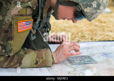 A U.S. Army Reserve Soldier plots points on a map during the Combat Support Training Exercise (CSTX) at Fort Knox, Kentucky, March 17, 2018. CSTX 2018 ensures Army reserve units are trained and ready to deploy on short notice and bring capable, combat ready, and lethal firepower in support of the Army and our joint partners anywhere in the world. (U.S. Army Image collection celebrating the bravery dedication commitment and sacrifice of U.S. Armed Forces and civilian personnel. Stock Photo