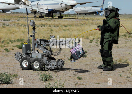 Staff Sgt. Michael Sprouse from San Diego, Calif., an explosive ordnance disposal team leader with the 741st Ordnance Company, 3rd Ord. Battalion., at Fort Bliss, Texas, passes off a suspected exercise improvised explosive device to an ANDROS EOD robot at Pinal Air Park, Ariz. during Raven’s Challenge XII, March 19-23. The Raven’s Challenge Exercise is an annual, interagency, counter IED exercise that incorporates scenarios focused on interoperability capabilities between public safety bomb squads (PSBSs) and military EOD units in operational environments. Image collection celebrating the brav Stock Photo