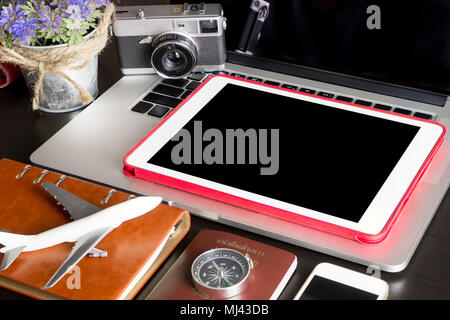 Blank empty tablet with travel objects on office table Stock Photo