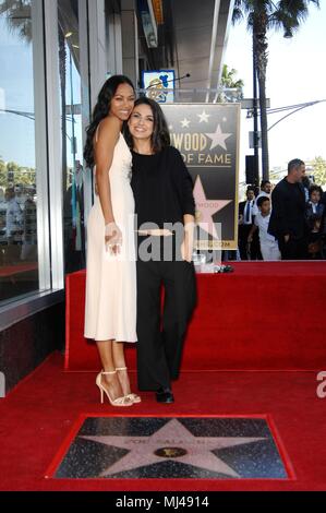 Zoe Saldana, Mila Kunis at the induction ceremony for Star on the