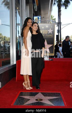 Zoe Saldana, Mila Kunis at the induction ceremony for Star on the