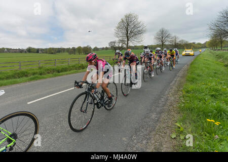 Near Denton, North Yorkshire, 4th May 2018. Close-up of group of female or women cyclists in the Asda Women's Tour de Yorkshire, racing past Denton Hall, on straight countryside lane near Ilkley, North Yorkshire, England, UK. Credit: Ian Lamond/Alamy Live News Stock Photo