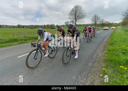 Near Denton, North Yorkshire, 4th May 2018. Close-up of group of female or women cyclists in the Asda Women's Tour de Yorkshire, racing past Denton Hall, on straight countryside lane near Ilkley, North Yorkshire, England, UK. Credit: Ian Lamond/Alamy Live News Stock Photo