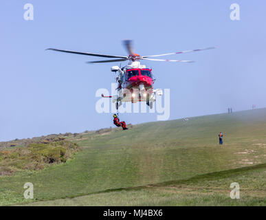 Beachy Head, Eastbourne, United Kingdom. 4th May 2018. The Coastguard Helicopter along with Sussex police and a local Coastguard ground crew respond to an incident at the base of Beachy Head cliffs. Initial reports indicate that what was thought to be a body seen in the water was in fact a mannequin placed there earlier by a film crew and possibly thrown from the cliff.  Eastbourne Council are making enquiries saying, filming permission was not given in the area. Yesterday 2 bodies were recovered from the cliff base, a male in vehicle and an unrelated female.Credit: Alan Fraser/Alamy Live News Stock Photo