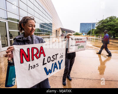 Dallas, USA. 4th May, 2018. She got wounded when a gun accidentally went off, and says there have been 12 of her friends either wounded or killed by guns. So she came on her own from Austin, Texas, to tell the NRA how she feels about guns. Credit: J. G. Domke/Alamy Live News Stock Photo