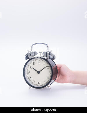 alarm clock with hand. alarm clock with hand on background. Stock Photo
