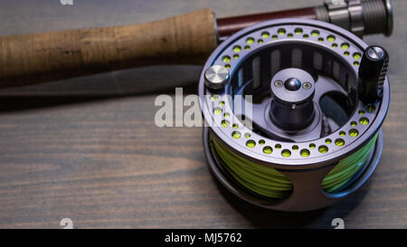 Fly fishing rod with cork handle grip and a left hand retrieve fly fishing  reel spooled with fly line Colorado USA Stock Photo - Alamy