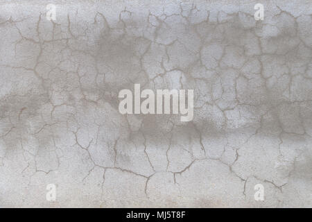 textured concreat wall with random crack lines and light and darker gray areas Stock Photo