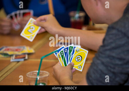 Camp Foster Okinawa Japan A Participant Draws A Card While Playing Uno During English Fun And