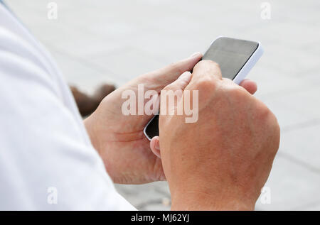 A person uses a smartphone. Stock Photo