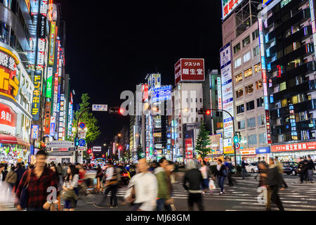 Tokyo, Japan - October 26, 2014: People walking along the streets of Shinjuku shopping at night, Shinjuku is a special wards located in Tokyo Metropol Stock Photo
