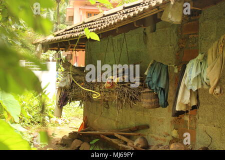 Indian culture and poverty with clothes hanging outside in a hut Stock Photo