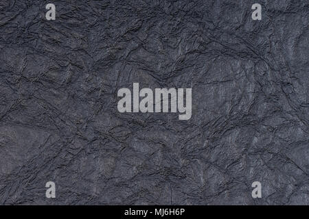 Black self made paper pressed sheet texture background. Embossed lace pattern. Stock Photo