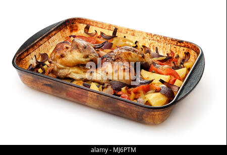 Baked chicken with vegetables in glass baking tray isolated on white Stock Photo