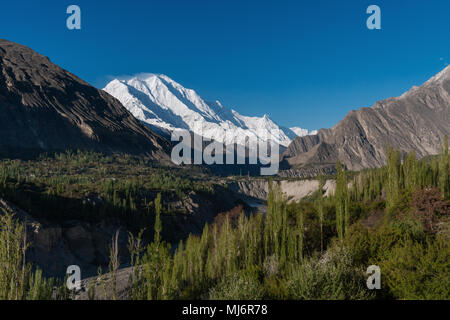 Hunza valley landscape, summer forest and mountain ridge with Rakaposhi mountain peak in Pakistan Stock Photo