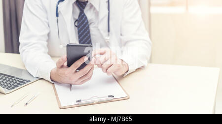 Doctor working and searching information on mobile at office. Treatment and technology concept. Picture for add text message. Backdrop for design art  Stock Photo